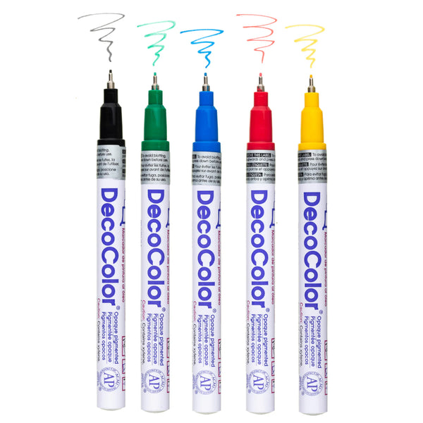 5 different colour oil based markers without caps on a white background 