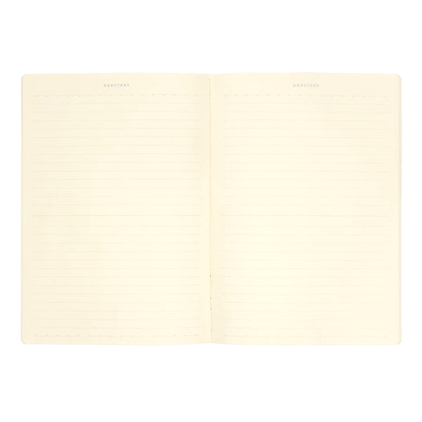Lined cream-colored notebook with a on a white background