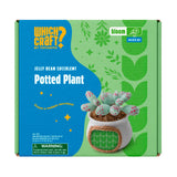 The product packaging box for a 'Which Craft? by Toymouth' Jelly Bean Succulent Potted Plant kit. The box features a bright blue and green design with illustrations of leaves and stars, and a photo of the completed craft product showing a small succulent in a white pot with a green leafy roof.