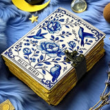 Decorative notebook with blue floral design on a blue textured surface