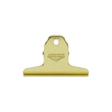 A gold-finished metal spring clip with a hanging loop and an embossed 'PENCO CLAMPY' logo, shown against a plain white background.