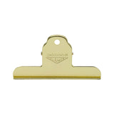 A gold-colored metal clipboard clip with a hanging loop and the brand name 'PENCO CLAMPY' embossed on the top, shown against a plain white background.