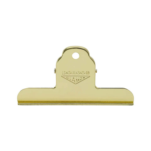 A gold-colored metal clipboard clip with a hanging loop and the brand name 'PENCO CLAMPY' embossed on the top, shown against a plain white background.